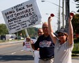 Robert Matis, centre holding sign, Lori Multari, right,  and Jim Allen, behind, join area residents and concerned television viewers for a rally at Cogeco Cable's Dougall Road studios to voice their displeasure with the decision to drop Bill Kelso, Brian Trenholm and Domenic Papa from their Windsor Spitfires broadcasts August 23, 2012. (NICK BRANCACCIO/The Windsor Star)