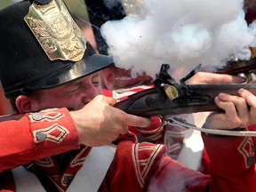 A historical reenactor, from Amherstburg, Ontario fires a musket during a War of 1812 ceremony along River Canard  on July 16, 2012. (Jason Kryk/The Windsor Star)