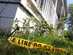 Police tape sits on the front lawn of a house at 868 Brant St. in Windsor, Ont. on Sunday, Aug. 19, 2012, where a home invasion and stabbing took place Saturday, night.  (DAX MELMER/The Windsor Star)