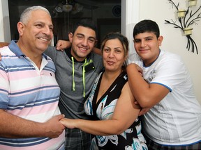 Lottery winner Faiz Putrus, left, with his sons Faraj, 17, and Fadi, 14, right, and wife Alamm Azer at their Windsor, Ont. home Wednesday Aug. 22, 2012.  (NICK BRANCACCIO/The Windsor Star)