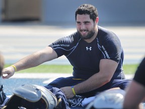 Defensive lineman Andrew Bakos stretches during a University of Windsor Lancer football practice Wednesday. (DAN JANISSE/ The Windsor Star)