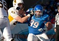 Catholic Central grad Mike Atkinson, right, tries to get to the quarterback against Wyoming last year. (JOHN KELLY/Courtesy of Boise State University)