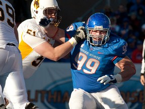 Catholic Central grad Mike Atkinson, right, tries to get to the quarterback against Wyoming last year. (JOHN KELLY/Courtesy of Boise State University)