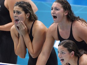 LaSalle's Amanda Reason, top right, cheers on teammate Brittany MacLean in the women's 4 x 200-metre freestyle relay at the 2012 London Olympics. (MIKE RIDEWOOD/The Canadian Press)