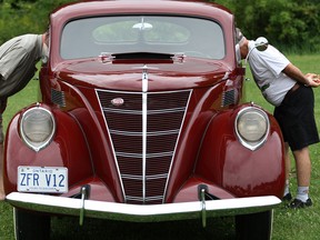 Al Friesen, left, and Norm Grondin, check out the interior of a 1937 Mercury Zephyr at this 2011 classic car show. (DAX MELMER/The Windsor Star)