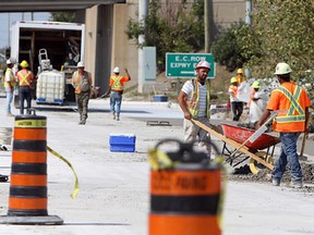Workers labour on the 3100 block of Walker Road Aug. 31, 2012. (Tyler Brownbridge / The Windsor Star)
