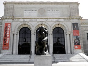 Auguste Rodin's sculpture "The Thinker" is shown outside The Detroit Institute of Arts in Detroit, Tuesday, July 10, 2012. The Detroit Institute of Arts is working to persuade voters to authorize a tax to support the cultural institution, promising free admission and expanded programing if it passes while raising the possibility that the museum would be a shadow of its current self if it's rejected.(AP Photo/Paul Sancya)