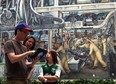 Brian Martin 41, Karen Martinek, 42, and Emma Martin, 11, from Portland ,Oregon use the interactive device to learn about the Diego Rivera mural at the Detroit Institute of Arts in Detroit, Mich.,Thursday, July 19,  2012. They have Detroit roots and are visiting family in the area. SUSAN TUSA/Detroit Free Press