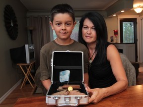 WINDSOR, ONTARIO - AUGUST 9, 2012 --FOR BRIGHTSIDE -- Portrait of Liliana Glen and her son, Ryan Glen, age 8, for story on the  unknown man who returned a box containing cash from a fundraising event.  The box was mistakenly left behind and returned with all money accounted for.  (JASON KRYK/ The Windsor Star)