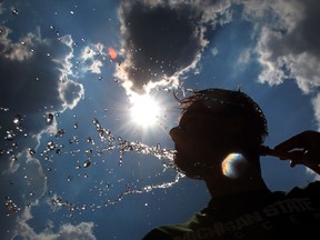 Windsor Legion track athlete Shawn Beaudoin, 18, cools off with water during practise at the University of Windsor on in this July 2012 file photo. A heat warning has been issued for Windsor and Essex County this holiday weekend. (JASON KRYK/The Windsor Star)