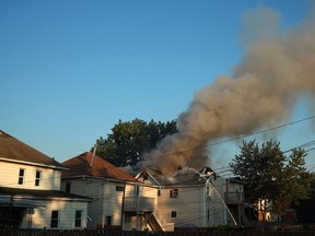 WINDSOR, ONT.:AUGUST 25, 2012 -- Firefighters battle a blaze on the 1000 block of Albert Road in Windsor, Ont., Saturday, August 25th, 2012.  Three different houses were damaged in the blaze that broke out early Saturday morning.  (DAX MELMER/The Windsor Star)