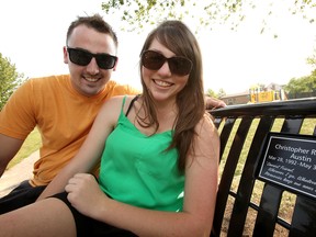 AMHERSTBURG, ONT: Ryan Lee and Michelle Pelaccia sit on a bench they raised money for to purchase in memory of their childhood friend at a park behind St. Joseph Parish Sunday, August 26 in River Canard. Christopher Austin, 20, was killed in a tragic boating accident in May. The bench is situated by the elementary and high school Austin attended and where his family lives. (KRISTIE PEARCE/THE WINDSOR STAR)