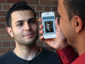 In this file photo, University of Windsor engineering students Samer Toukan, left, and Gagandeep Dulay demonstrate their IPhone app to help the visually impaired on Aug. 3, 2012.  (NICK BRANCACCIO/The Windsor Star)