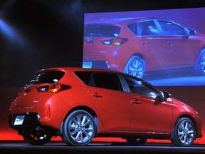 A model stands next to a redesigned compact hatchback Toyota Auris during a press preview in Tokyo on Aug. 20, 2012.  Toyota Motor Corporation announced the Japan launch of the completely redesigned Auris, a strategic compact model for the Japanese and European markets.  (AFP photo / KAZUHIRO NOGIKAZUHIRO NOGI/AFP/GettyImages)