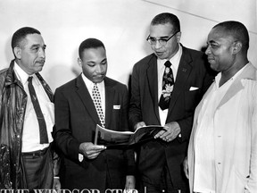 Rev. Martin Luther King, leader of the recent bus boycott in Montgomery Ala., was guest speaker Sunday, Aug. 5, 1956 at the Emancipation Day celebration at Jackson Park. Left to right is Russel Small, Rev. Martin Luther King, Rev.Theodore Boone and Walter Perry. (The Windsor Star-FILE)