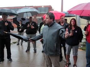 Ken Lewenza Jr., speaks with workers from Klinec Manufacturing Ltd. on St. Luke Road in Windsor, Ontario during an early morning protest in Windsor, Ontario on August 14, 2012.  CAW members joined the non-unionized workers in their protest against the employer who has requested a reduction in pay. (JASON KRYK/ The Windsor Star)