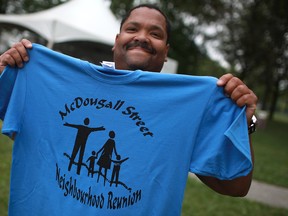 Greg Martin, president of the North Star Cultural Community Centre, holds up the 2012 T-shirt for the McDougall Street Neighbourhood Reunion at Wigle Park in Windsor, Ont., Saturday, August 11, 2012. (DAX MELMER/The Windsor Star)