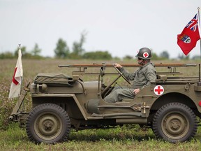 A medic sits in a jeep waiting to join the action during a military re-enactment at the Southern Ontario Military Muster at the Canadian Transportation Museum and Heritage Village on Aug.13, 2011. (DAX MELMER/The Windsor Star)