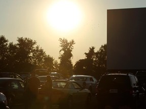 Movie-goers wait for the sun to set so the show can begin at Stevie Rae's Southwestern Drive-in in Tilbury, Ont., Friday, July 20, 2012. This is the opening night for the drive-in as a packed house came to see the premiere of the latest Batman movie, The Dark Knight Rises. (DAX MELMER/The Windsor Star)