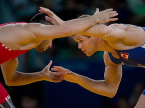Canada's David Tremblay in action against Turkey's Ahmet Peker in the 55-kilogram division of men's freestyle wrestling at the London Olympics on Aug. 10, 2012. (Sean Kilpatrick / The Canadian Press)