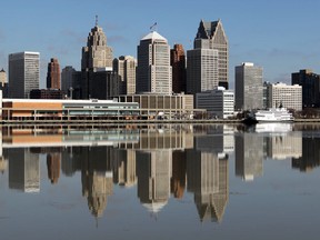 The Detroit skyline is reflected in the Detroit River on a calm February day  as seen from Windsor, Ontario.