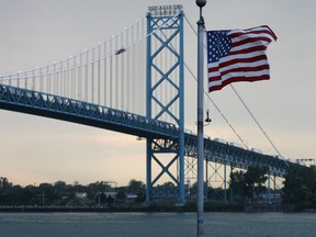 An American flag flies in front of the Ambassador Bridge in this 2006 file photo.