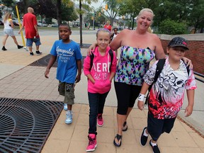 Susan Freeswick walks with her son, Zack Freeswick, 11, and family friends Curtis Mathis, 8, left, Kyleigh Mallen, 10, at General Brock Public School on Sandwich Street Tuesday September 4, 2012. Thousands of area students returned to classrooms Tuesday. (NICK BRANCACCIO/The Windsor Star)