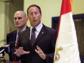 Honourable Peter MacKay, right, Minister of National Defence along with local MP Jeff Watson were joined by Commander Dan Manu-Popa, (not shown) HMCS Hunter Naval Reserve during an announcement of the construction of a new building at Mill Cove Marina on the Detroit River, September 6, 2012. (NICK BRANCACCIO/The Windsor Star)