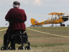 George Mock, 87, watches as a 1941 Canadian deHavilland Tiger Moth lands at the Windsor International Airport, Saturday, Sept. 29, 2012.  The airport was holding an open house for the public.  (DAX MELMER/The Windsor Star)