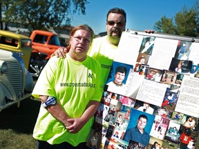 Tim and Denise Baxter stand next to a collage of pictures of their son, Andrew Baxter, who passed away in 2003, at the annual Andrew Baxter Memorial Car and Bike Show at Harmony in Action, Saturday, Sept. 15,  2012.  (DAX MELMER/The Windsor Star)