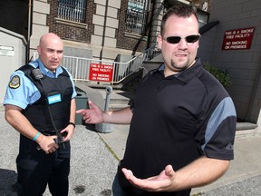 Correctional officer Randy Simpraga, right, speaks with an unidentified officer, left,  following a noon hour protest in front of the Windsor Jail, September 11, 2012. (NICK BRANCACCIO/The Windsor Star)