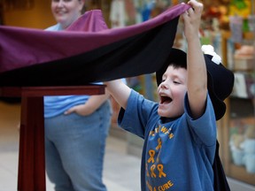 Former patient Xander Reid, 6, and his family take part in Childhood Cancer Awareness Day at Windsor Regional Hospital Met Campus Sept.19, 2012. In photo, Xander works with magician Ron Gudel (not shown) levitating a table off the floor. (NICK BRANCACCIO/The Windsor Star)