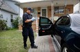 CBSA officers record vehicle information from a Pontiac in front of a home at 1616 Cadillac Rd. Tuesday, Sept. 25, 2012. Neighbours witnessed RCMP and CBSA officers from multiple cruisers pulling up to the address armed with a search warrant.  (NICK BRANCACCIO/The Windsor Star)