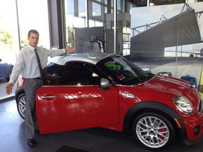 Rafih Automotive Group Sales Associate shows off a MINI Cooper in anticipation of GenNext's MINI Networking Event on September 27, 2012 at Overseas Motors Mini. The event will draw young professionals and mystery celebrity guests to network but with one fun twist - the networking will take place behind the wheels of a new MINI Cooper.