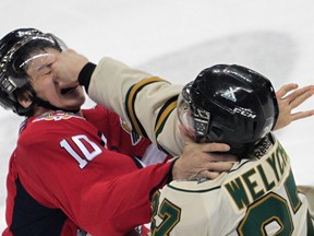 Windsor Spitfires Sam Studnicka, left, take a punch in the face from  London Knights Brett Welychka  at the WFCU Centre in Windsor on March 29, 2012. Letter writer Kevin Priscak says hockey will never change when it comes to fighting. (JASON KRYK/ The Windsor Star)