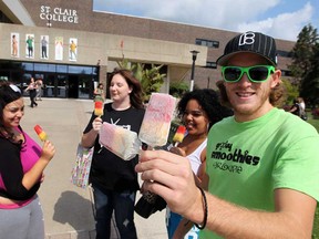 Groovy Smoothies creator Ben Simpson, right,  attends a young entrepreneurs showcase event at St. Clair College in Windsor, Ont., where they handed out samples of the tasty, frozen treats to students Wednesday, September 5, 2012. (NICK BRANCACCIO/The Windsor Star)