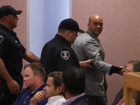 Edy Haddad is escorted from the gallery during a city council meeting at city hall in Windsor, Ont. on Tuesday, September 4, 2012.          (The Windsor Star / TYLER BROWNBRIDGE)