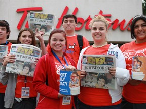 F.J. Brennan Catholic High School students, from left, Deion Menard, 15, Tara Bruce, 15, Jake Clark, 16, Tyarra Ouellette, 16, Hayley Bruce, 15, and Alexandra Hanna, 16, help to raise money for the Postmedia Raise-a-Reader campaign, outside of the Tim Hortons at the intersection of Wyandotte Street East and St. Louis Avenue, Thursday, Sept. 20, 2012.  (DAX MELMER/The Windsor Star)