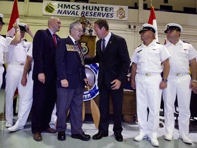 Honourable Peter MacKay, centre right, speaks with Canadian veteran Larry Costello, centre, and MP Jeff Watson at the HMCS Hunter Naval Reserve during an announcement for the construction of a new building at Mill Cove Marina in Windsor, Ont., on the Detroit River, September 6, 2012. Canadian Naval officers joined in the photo opportunity. (NICK BRANCACCIO/The Windsor Star)