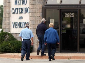 Employees of Metro Catering enter their office in Windsor, Ont. on Tuesday, September 25, 2012. Current employees are being asked to reapply for their jobs with a new company Choice Nutritional Food Service and Vending.                (TYLER BROWNBRIDGE / The Windsor Star)