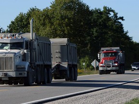 In this file photo, dump trucks head towards the 401 on Puce Road in Lakeshore on Monday, September 10, 2012. Ryan Hill and other area residents are upset by the number of trucks hauling parkway construction dirt along the road.  (The Windsor Star / TYLER BROWNBRIDGE)