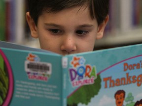 In this file photo, Marco Kurepa reads a Dora book at the Nikola Budimir Library in Windsor on Tuesday, September 27, 2011.                 (TYLER BROWNBRIDGE / The Windsor Star)