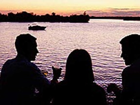 In this file photo, a group watches the sun set while taking in the annual Shores of Erie International Wine Festival in Amherstburg.  (TYLER BROWNBRIDGE / The Windsor Star)