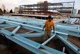 Ironworker Dale Eveson of Local 700 is dwarfed by huge steel trusses on Thursday, Sept. 6, 2012, which will be installed across the width of the main pool at Windsor's Family Aquatic Centre. Cranes will arrive near Pitt Street and Bruce Avenue to lift the trusses into place early next week. The main truss span is 48 metres.  (NICK BRANCACCIO/The Windsor Star)