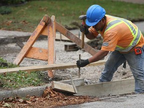 A construction crew works to replace the sidewalks on Windermere Road in Windsor, Ont. on Tuesday, September 25, 2012.         (TYLER BROWNBRIDGE / The Windsor Star)