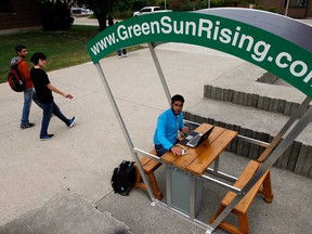 University of Windsor chemistry student Abdullah Allawnha uses GreenSunRising solar recharging station near the Leddy Library Wednesday, September 26, 2012. (NICK BRANCACCIO/The Windsor Star)