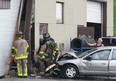 Windsor firefighters work at the scene of an accident at a commercial building at 825  Tecumseh Rd. W. in Windsor, Ont. A man lost control of the car and struck the building. A female passenger received minor injuries. There was significant damage to the car and building.   (DAN JANISSE/ The Windsor Star)