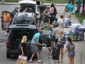 Students get help from their families as they move their things into residences at the University of Windsor on Sept. 2, 2012.  (DAX MELMER/The Windsor Star)