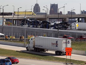 A tractor-trailer takes newly opened Exit 47C off of northbound I-75 as officials with Michigan Department of Transportation, right, hold a press conference on Sept. 21, 2012.   (NICK BRANCACCIO/The Windsor Star)