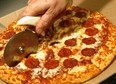 File photo of a pizza getting sliced up. (Getty Images files)